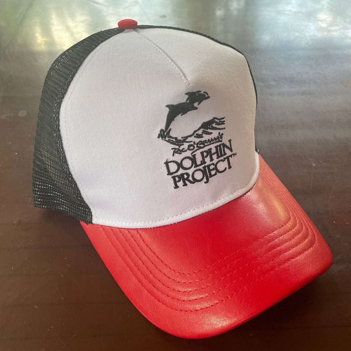 Dolphin Project Trucker Hat in red white and black